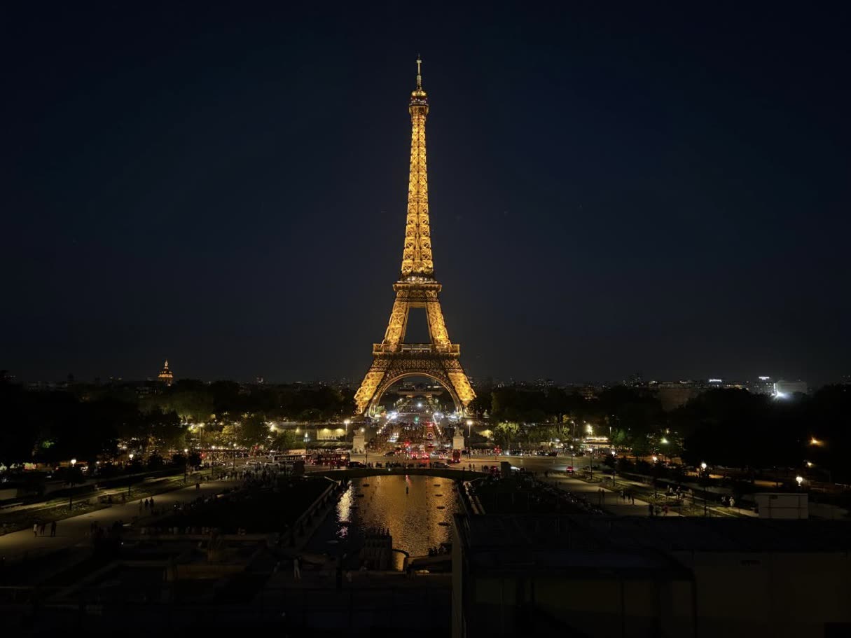 The Eiffel Tower illuminated above Paris at night