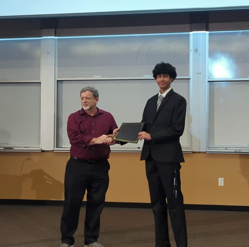 Receiving a certificate folder during an award presentation