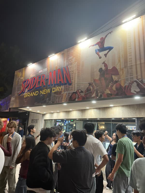 COSMOS students gathering outside a Spider-Man show at night