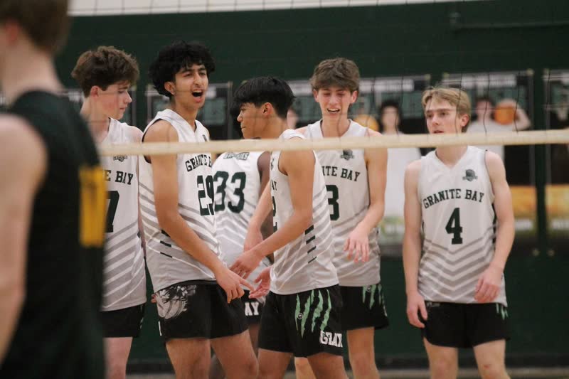 Granite Bay volleyball players standing behind the net during a match