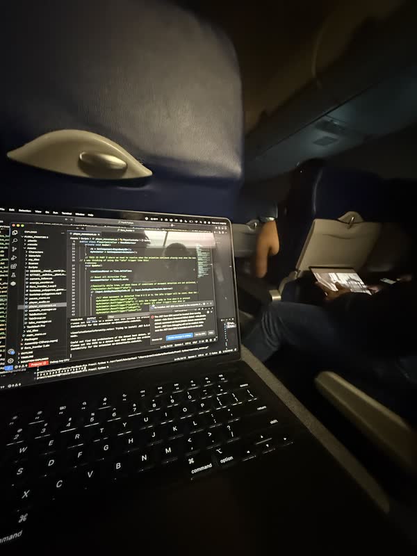 Flora Frontier open in a code editor on Pranil's laptop during a night flight