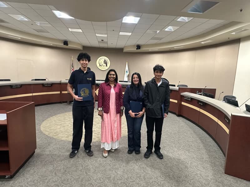 Standing with a certificate folder in a formal chamber