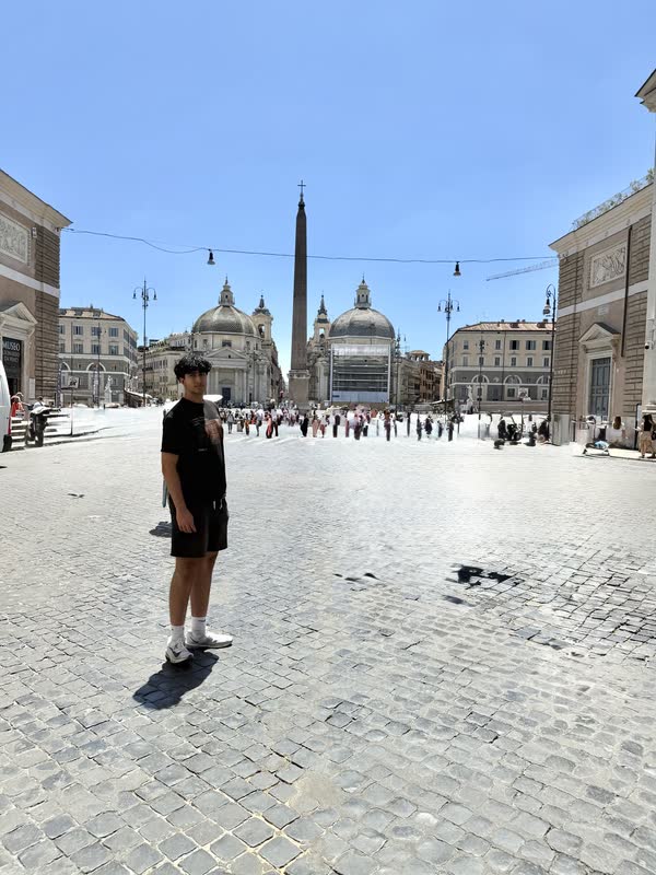 Pranil standing in Piazza del Popolo between its twin churches and central obelisk