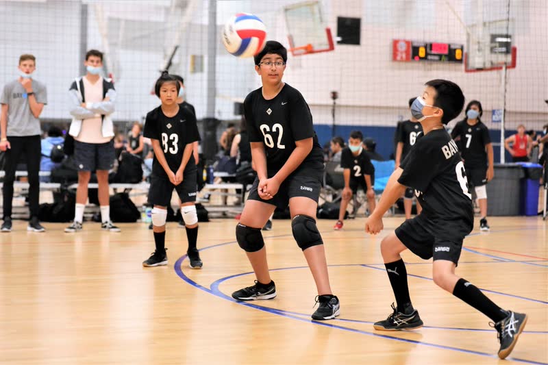 Youth volleyball player passing the ball during a match